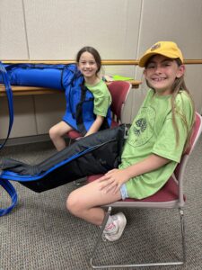 2 girls using a lymphedema sleeve.