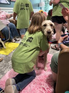A girl hugging a therapy dog.