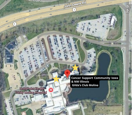 Satellite view of Cancer Support Community Iowa & NW Illinois Gilda’s Club Moline. A red pin and yellow stars mark the facility within the UnityPoint Health Trinity Moline Hospital complex, situated near John Deere Road.